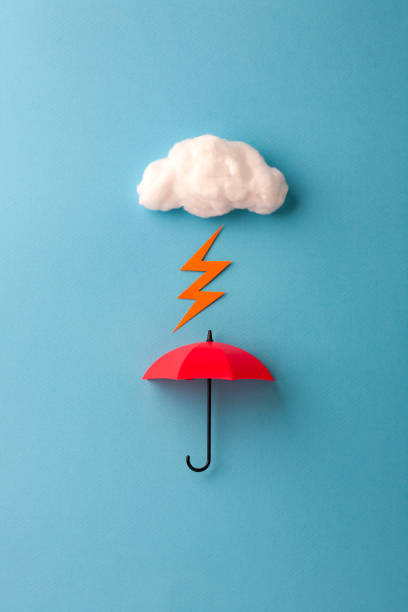 istock red umbrella under the cloud on sky blue background 1167729183