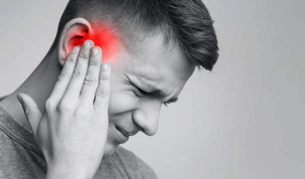 istock Sick man having ear pain, touching his painful head 1167729524