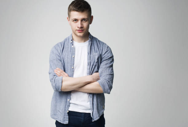 istock Young man standing with his arms crossed 1167729639