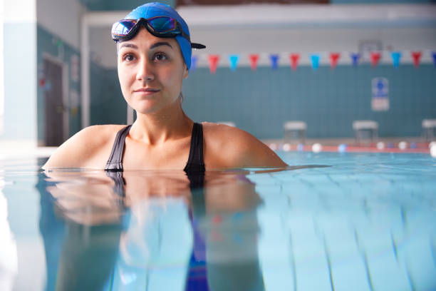 istock Female Swimmer Wearing Hat And Goggles Training In Swimming Pool 1167732412