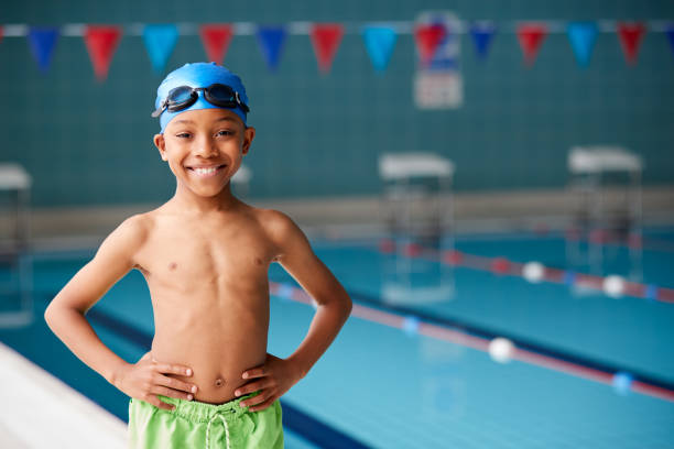 retrato do menino que está pela borda da piscina pronta para a lição - touca de natação - fotografias e filmes do acervo