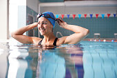 Female Swimmer Wearing Hat And Goggles Training In Swimming Pool