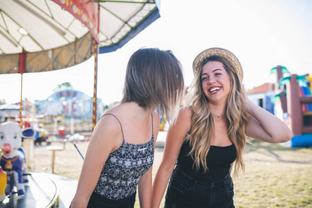 istock Two beautiful girls having fun at amusement park 1167733966