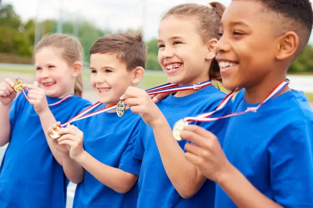 Photo of Children Showing Off Winners Medals On Sports Day