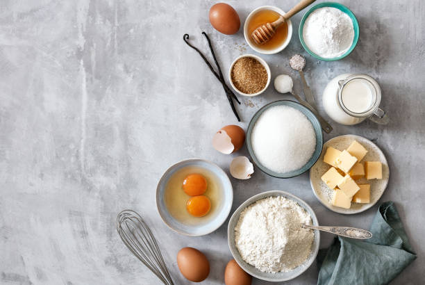 Baking ingredients: flour, eggs, sugar, butter, milk and spices Baking ingredients: flour, eggs, sugar, butter, milk and spices on gray marble background. Top view. Space for text baking stock pictures, royalty-free photos & images