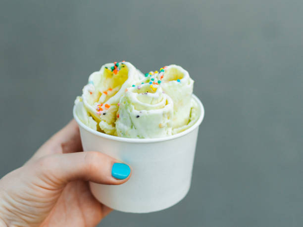 istock Hand holding rolled ice cream in cone cup 1167734138