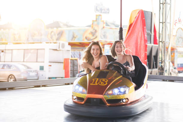 istock Two young women having a fun bumper car ride at the amusement park. 1167734263