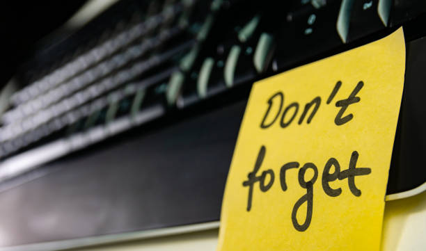 istock Yellow paper note with  password  don't forget on  part of keyboard 1167734277