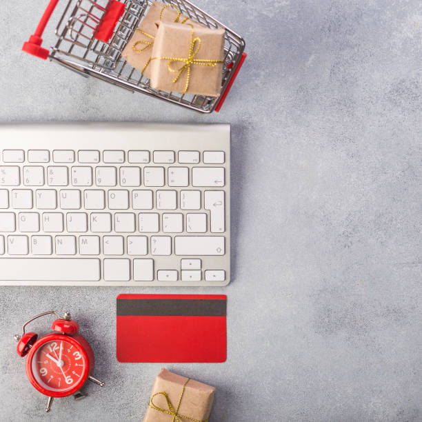 Concept online shopping buying presents. Red credit card, keyborad and christmas presents on grey table flat lay, copy space. Business christmas holidays concept, holiday gift online shopping concept. Save time Concept online shopping buying presents. Red credit card, keyborad and christmas presents on grey table flat lay, copy space. Business christmas holidays concept, holiday gift online shopping concept keyborad stock pictures, royalty-free photos & images