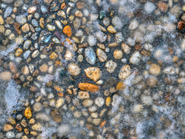 istock sidewalk of pebbles with ice 1167736900