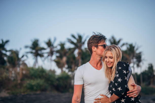istock Couple in love taking a walk on the beach 1167737934