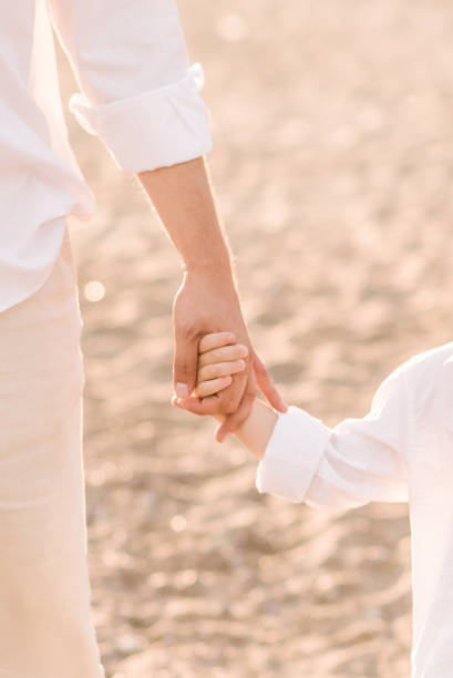 istock Father holding his son's hand 1167740969