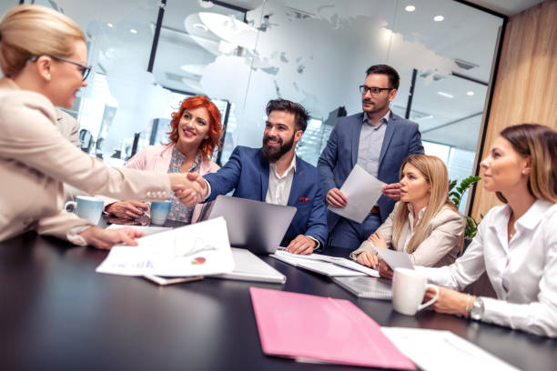 istock Group of business people working and communicating while sitting at the office desk 1167741157