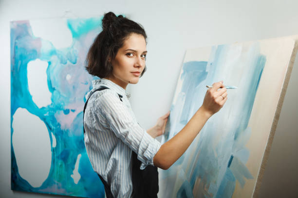 istock Concentrated woman focused on creative art-making process in art therapy 1167742035