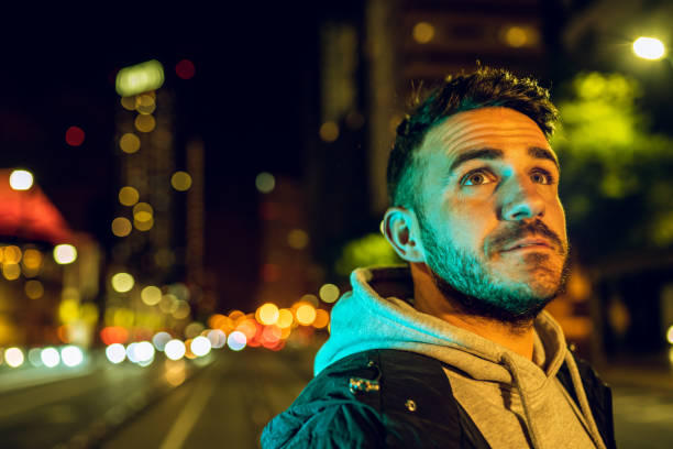 Casual man wearing a jacket in the street at night stock photo