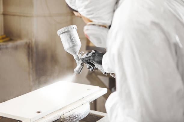 istock Man working with paint spray gun, airless spraying to wood 1167743237