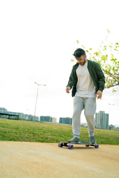 istock Man having fun with his longboard in a park. 1167743566