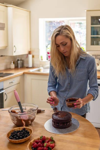 istock Attractive woman baking a cake at home 1167743568
