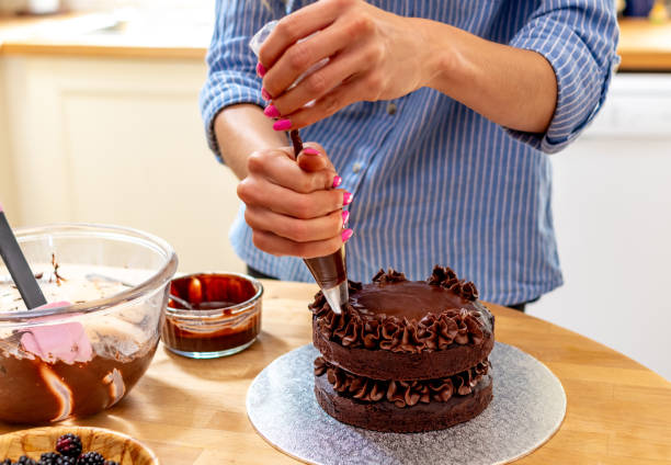 istock Piping icing on to a chocolate cake 1167743912