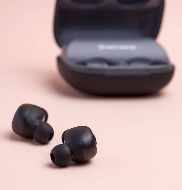 istock black wireless little earphones and a charging box 1167745078