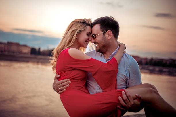 istock Happy couple enjoying in sunset 1167745148