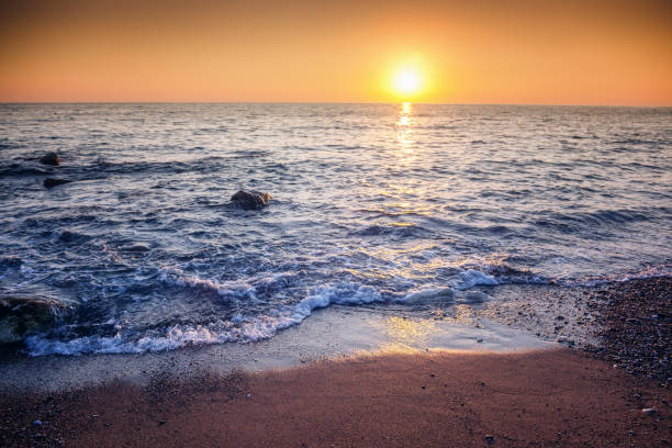 istock beautiful sunset on the sea shore, stunning scenery, pebble beach 1167745350