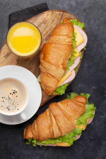 istock Coffee, orange juice and croissant sandwich 1167746276
