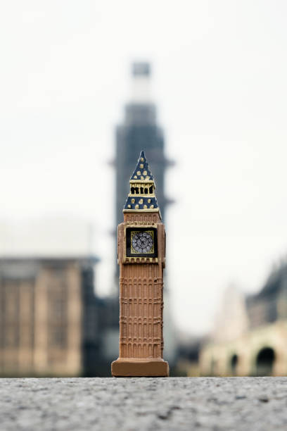 a miniature of the Clock Tower in front of the original tower of the Palace of Westminster in London, United Kingdom