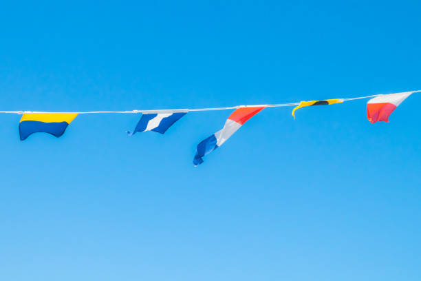 istock Nautical flags on the ship against blue sky 1167748323