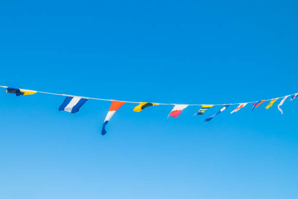istock Nautical flags on the ship against blue sky 1167748828