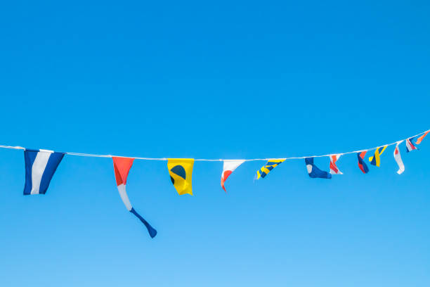 istock Nautical flags on the ship against blue sky 1167749007