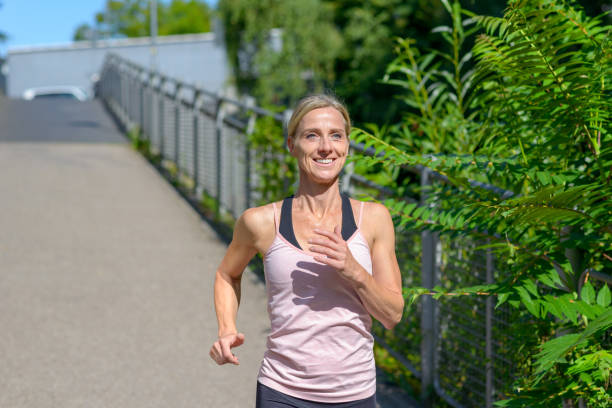 istock Determined woman smiling happy while jogging 1167750365