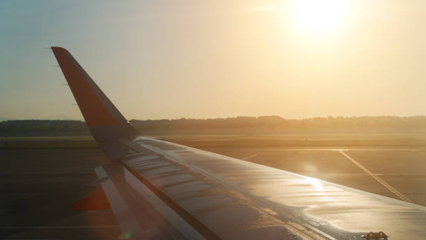 istock Part of airplane on the runway at sunset. 1167751711