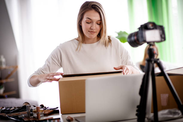 istock Female blogger opening a box on a live stream 1167753136