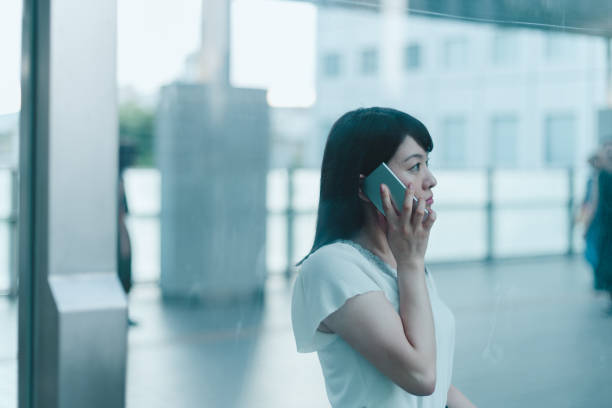 istock Talking on the smartphone through the glass 1167753257