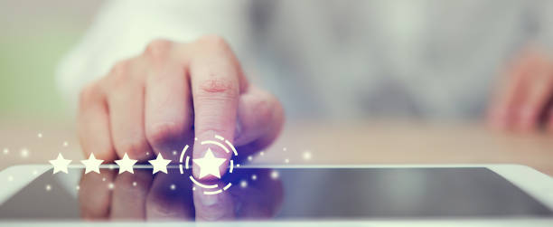 close up on businessman hand pressing on digital tablet screen with five star rating feedback to give excellent job concept