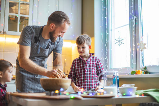 family cooking christmas cookies at the kitchen - pastry cutter family holiday child imagens e fotografias de stock