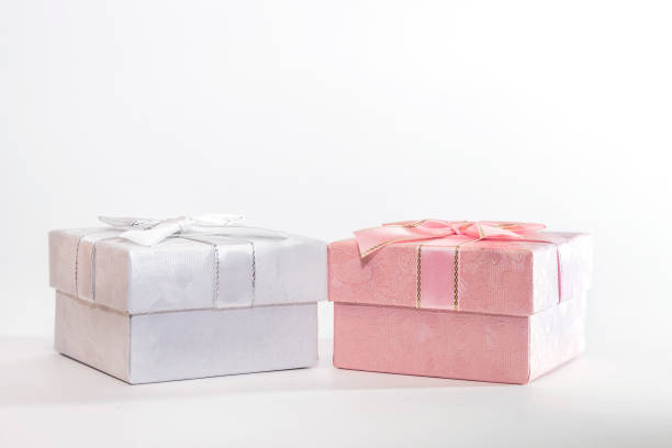 istock Two decorative holiday gift boxes with ribbon bow for congratulations, surprise, white and pink presentations on a white background with copy space 1167757159