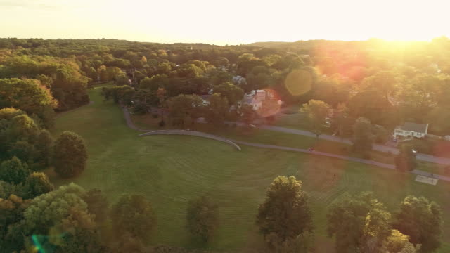 Aerial view of a park and residential area in Springfield, New Jersey, USA, at sunset. Drone video with the panoramic camera motion.