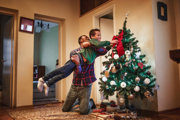 istock Father and sun having fun. It's Christmas time in home 1167761241