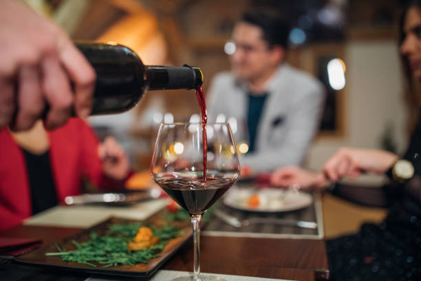 istock Waiter pouring red wine for dinner 1167761629