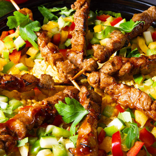 istock Lamb skewers with curry rice and different vegetables 1167763200