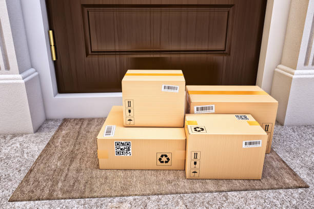 Internet shopping, online purchases, e-commerce and express package door-to-door delivery service concept Cardboard boxes on the door mat near the entrance door front stoop photos stock pictures, royalty-free photos & images