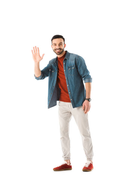 istock positive bearded man looking at camera and showing hello gesture isolated on white 1167767762
