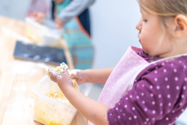 istock Little girl kneading dough 1167768767