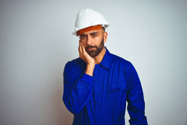 istock Handsome indian worker man wearing uniform and helmet over isolated white background thinking looking tired and bored with depression problems with crossed arms. 1167770791