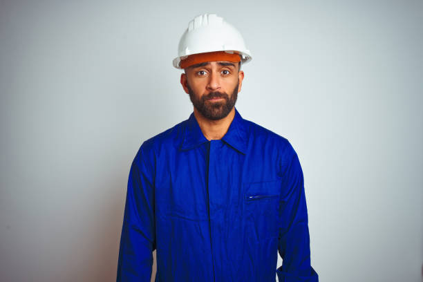 istock Handsome indian worker man wearing uniform and helmet over isolated white background depressed and worry for distress, crying angry and afraid. Sad expression. 1167770795