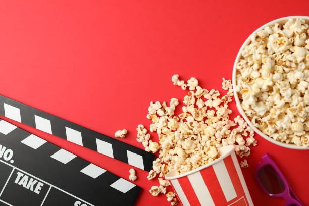 istock Flat lay. Buckets with popcorn, 3d glasses and clapperboard on red background 1167770910