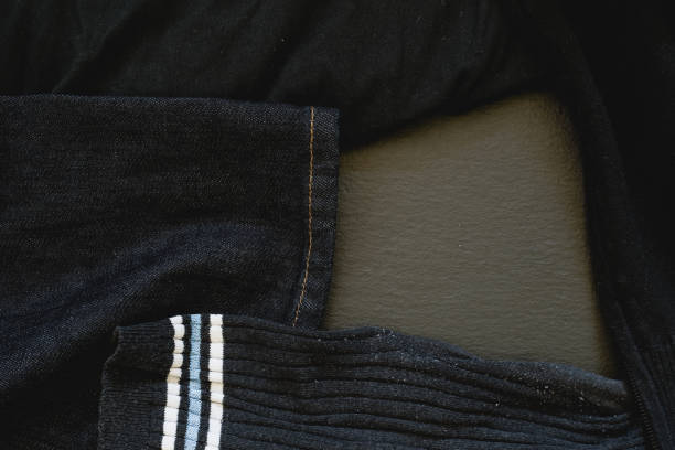 istock Pile of dirty laundry on black background 1167772364