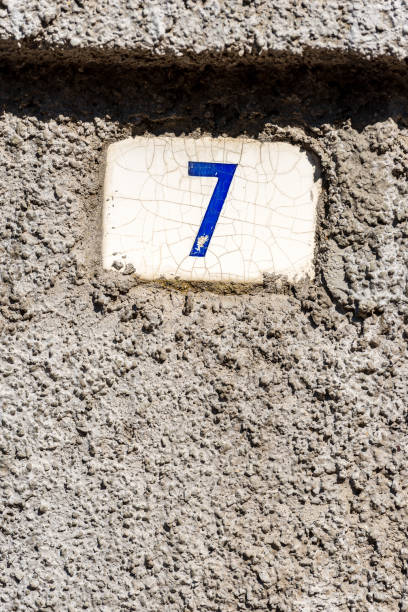House Number Seven - Liguria Italy Old house number seven on the wall in a small village. Liguria, Italy, Europe ceramic tile house numbers stock pictures, royalty-free photos & images